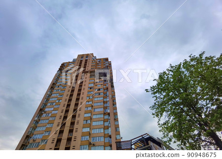 Kyiv, Ukraine - May 27, 2022: War of Russia against Ukraine. View of a civilian building damaged following a Russian rocket attack the city. Kyiv, Ukraine - May 27, 2022: War of Russia against Ukraine. View of a civilian building damaged following a Russian rocket attack the city. 90948675