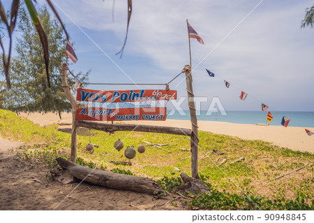 Natural tropical sandy beach and calm sea landscape with trees and blue sky background. Mai Khao beach on Phuket island, Thailand Natural tropical sandy beach and calm sea landscape with trees and blue sky background. Mai Khao beach on Phuket island, Thailand 90948845