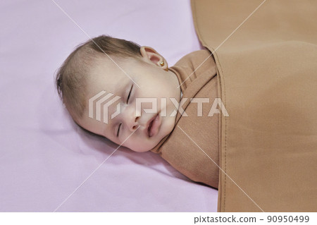Newborn baby girl, sleeping on a blanket. 90950499
