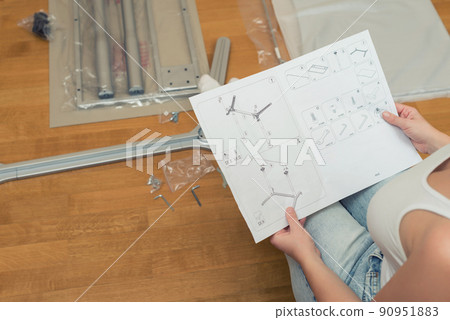 Instruction for furniture assembling in the female hands for self assembly. 90951883