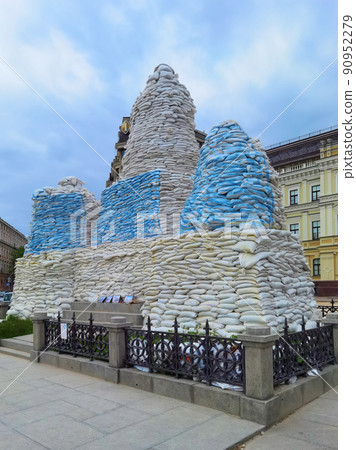 Kyiv, Ukraine, May 27, 2022: Covered monument to Princess Olga, St. Andrew the Apostle, educators Cyril and Methodius with sandbags to protect the historical heritage from Russian attack Kyiv, Ukraine, May 27, 2022: Covered monument to Princess Olga, St. Andrew the Apostle, educators Cyril and Methodius with sandbags to protect the historical heritage from Russian attack 90952279