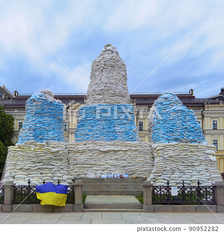 Kyiv, Ukraine, May 27, 2022: Covered monument to Princess Olga, St. Andrew the Apostle, educators Cyril and Methodius with sandbags to protect the historical heritage from Russian attack Kyiv, Ukraine, May 27, 2022: Covered monument to Princess Olga, St. Andrew the Apostle, educators Cyril and Methodius with sandbags to protect the historical heritage from Russian attack 90952282