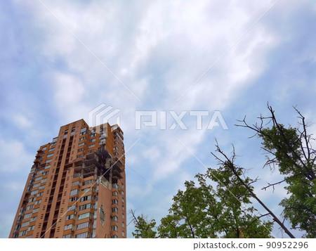 Kyiv, Ukraine - May 27, 2022: War of Russia against Ukraine. View of a civilian building damaged following a Russian rocket attack the city. Kyiv, Ukraine - May 27, 2022: War of Russia against Ukraine. View of a civilian building damaged following a Russian rocket attack the city. 90952296