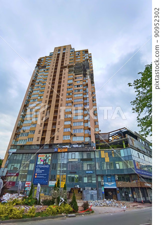 Kyiv, Ukraine - May 27, 2022: War of Russia against Ukraine. View of a civilian building damaged following a Russian rocket attack the city. Kyiv, Ukraine - May 27, 2022: War of Russia against Ukraine. View of a civilian building damaged following a Russian rocket attack the city. 90952302