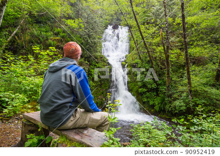 Hiker near waterfall 90952419