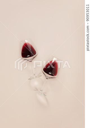 Flat-lay of red wine in glasses on pink background Flat-lay of red wine in glasses on pink background 90953011