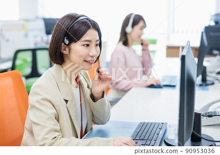 Call center operator receiving a call 90953036