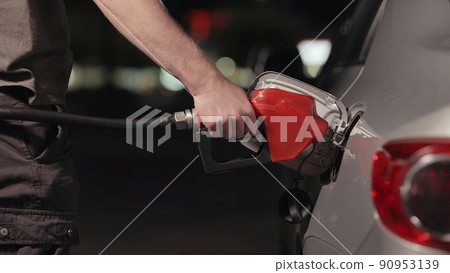 Fuel station nozzle filling car tank Fuel station nozzle filling car tank 90953139