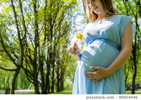 Healthy Pregnancy woman. Happy maternity mother in summer park. Baby belly. Pregnant walking nature. Concept of pregnancy, maternity, expectation. Healthy Pregnancy woman. Happy maternity mother in summer park. Baby belly. Pregnant walking nature. Concept of pregnancy, maternity, expectation. 90954046