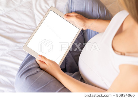 Pregnancy mockup digital tablet. Pregnant woman holding smart tablet. Mobile pregnancy online maternity application mock up. Concept maternity, pregnancy, childbirth. Pregnancy mockup digital tablet. Pregnant woman holding smart tablet. Mobile pregnancy online maternity application mock up. Concept maternity, pregnancy, childbirth. 90954060