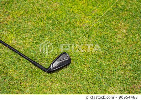 Top view of golf club on a green grass on golf course Top view of golf club on a green grass on golf course 90954468