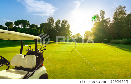 Golf cart on beautiful golf course at sunset 90954565