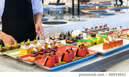 The chef decorates cakes in the hotel bar The chef decorates cakes in the hotel bar 90954642