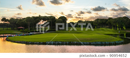 Golf course panorama at sunset with beautiful sky Golf course panorama at sunset with beautiful sky 90954652