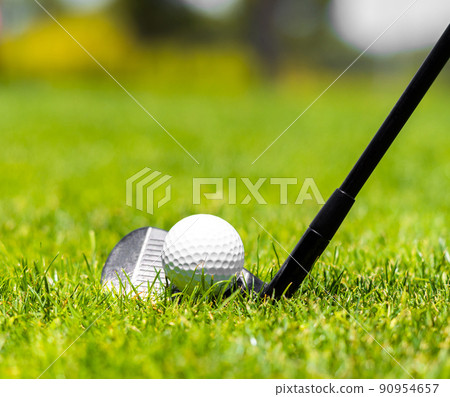 Golf iron club ready to hit a ball on green grass on golf course 90954657