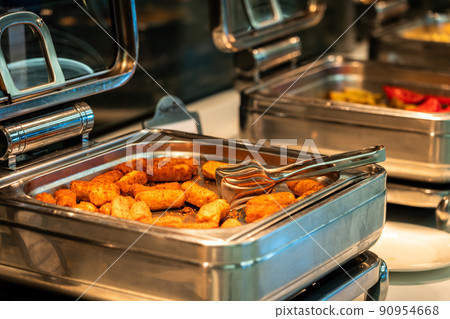 Heated buffet containers with potato sticks for breakfast in hotel restaurant Heated buffet containers with potato sticks for breakfast in hotel restaurant 90954668