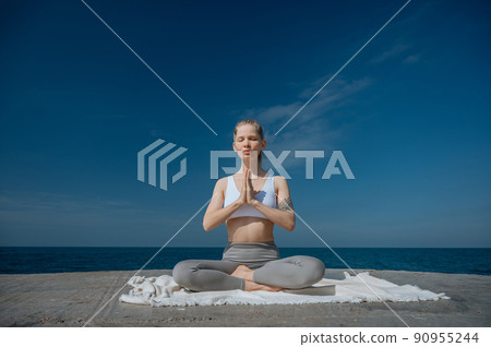 Yoga practice and meditation in nature. Woman practicing near Black sea. Yoga practice and meditation in nature. Woman practicing near Black sea. 90955244