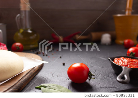 Pizza and dough homemade cooking with ingredients on table. Pizza with sauce on tabletop background Pizza and dough homemade cooking with ingredients on table. Pizza with sauce on tabletop background 90955331