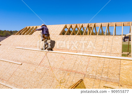 Home roof construction applying roof plywood panels in new house Home roof construction applying roof plywood panels in new house 90955877