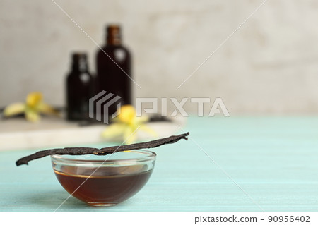 Aromatic homemade vanilla extract on light blue wooden table. Space for text Aromatic homemade vanilla extract on light blue wooden table. Space for text 90956402