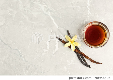 Flat lay composition with vanilla extract on light grey marble table. Space for text Flat lay composition with vanilla extract on light grey marble table. Space for text 90956406