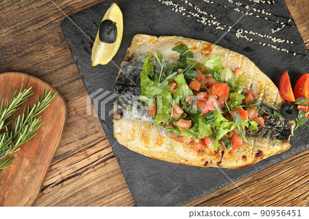 Delicious grilled fish served on wooden table, flat lay 90956451