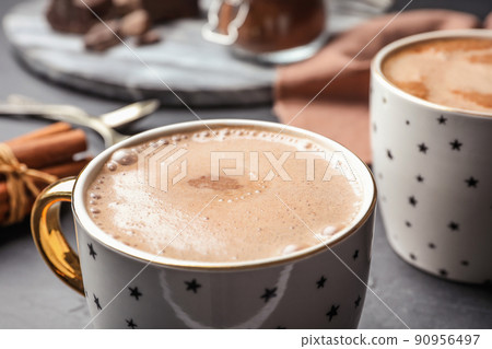 Cups of delicious hot cocoa on grey table, closeup 90956497