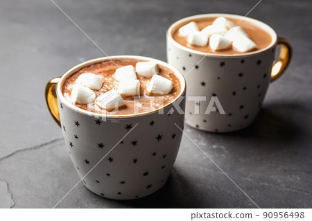 Cups of delicious hot cocoa with marshmallows on grey table Cups of delicious hot cocoa with marshmallows on grey table 90956498