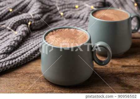Cups of delicious hot cocoa on wooden table 90956502