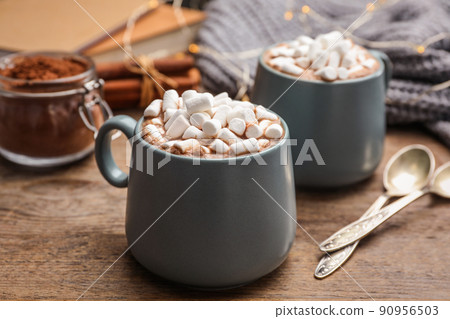 Cups of delicious hot cocoa with marshmallows on wooden table Cups of delicious hot cocoa with marshmallows on wooden table 90956503