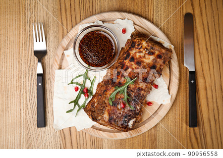 Delicious grilled ribs served on wooden table, flat lay 90956558