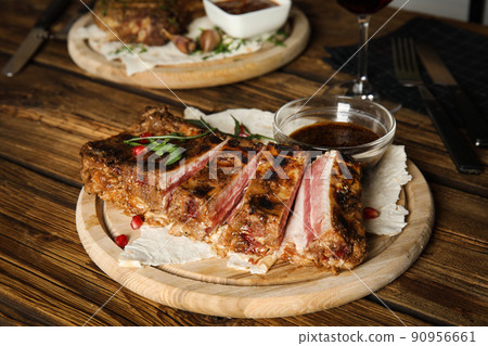 Delicious grilled ribs served on wooden table 90956661