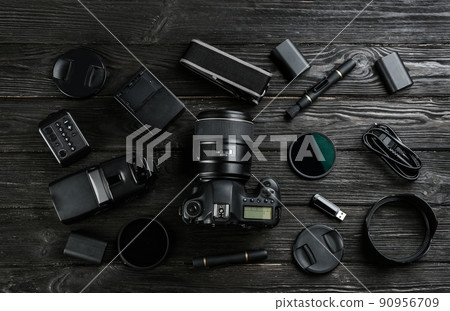 Flat lay composition with equipment for professional photographer on black wooden table 90956709