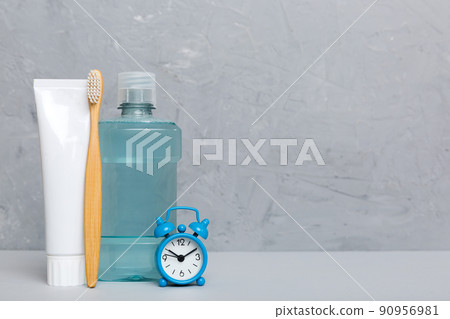 Mouthwash and other oral hygiene products on colored table top view with copy space. Flat lay. Dental hygiene. Oral care products and space for text on light background. concept 90956981