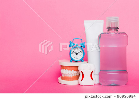Mouthwash and other oral hygiene products on colored table top view with copy space. Flat lay. Dental hygiene. Oral care kit. Dentist concept 90956984