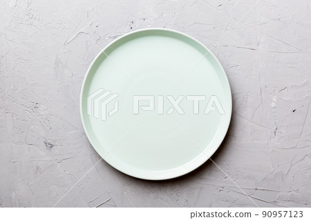 Top view of empty blue plate on cement background. Empty space for your design Top view of empty blue plate on cement background. Empty space for your design 90957123