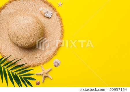 Summer holidays. Summer concept with straw hat and tropical leaf. Flat lay, top view, copy space 90957164