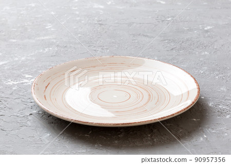 Perspective view of empty light plate on cement background. Empty space for your design 90957356