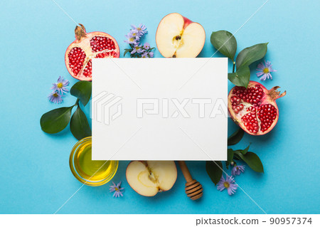 Flat lay composition with Blank flyer poster and symbols jewish Rosh Hashanah holiday attributes on colored background, New Year holiday Traditional. Top view with copy space mock up 90957374