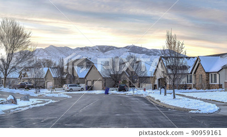 Pano Neighborhood street with road along houses overlooking mountain and cloudy sky 90959161