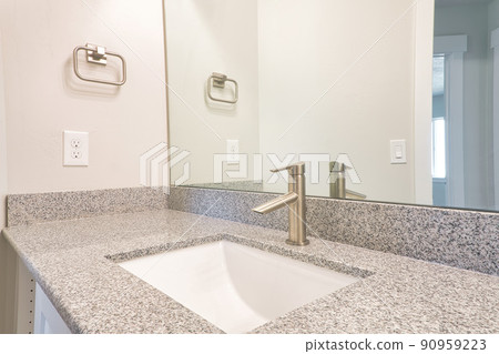 Rectangular sink and stainless steel faucet against mirror inside home bathroom 90959223