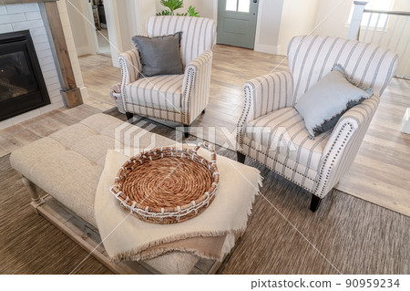 Cozy living room interior with armchairs and table in front of the fireplace 90959234