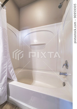 Shower tub in a bathroom with brown walls and wall-mounted fixtures 90959305