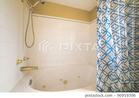 Shower tub combo with white tiles surround and gold fixtures 90959306