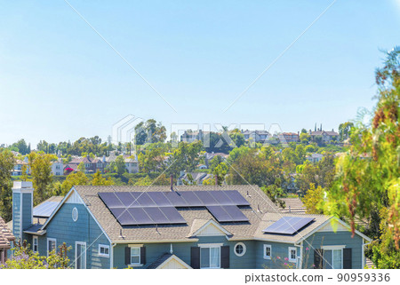 High angle view of a house with solar panels on the shingles roof 90959336