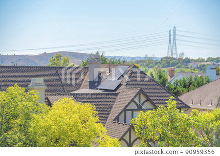 Solar panels on a suburban house with brown trims and shingles in Ladera Ranch, California 90959356