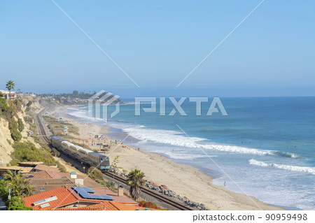Train passing near the beach at San Clemente, California 90959498