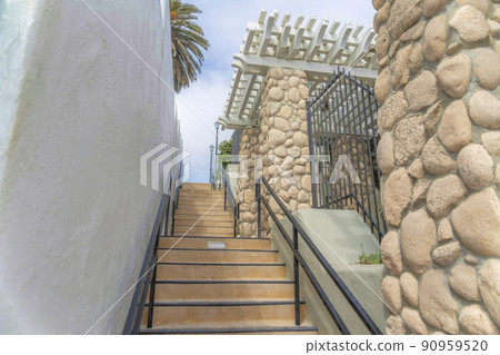 Concrete stairs with metal handrails in the middle of buildings at Carlsbad, San Diego, California Concrete stairs with metal handrails in the middle of buildings at Carlsbad, San Diego, California 90959520