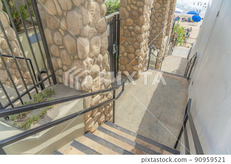 Stairs outside the fence and wall of the buildings at Carlsbad, San Diego, California 90959521
