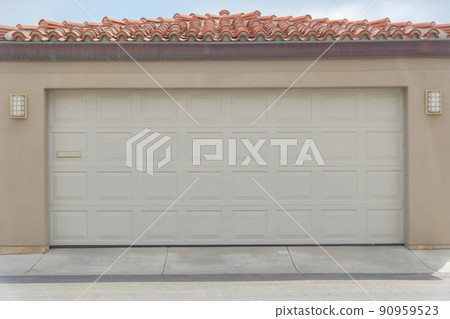 Garage exterior with sectional door and concrete tile roof at Carlsbad, San Diego, California 90959523